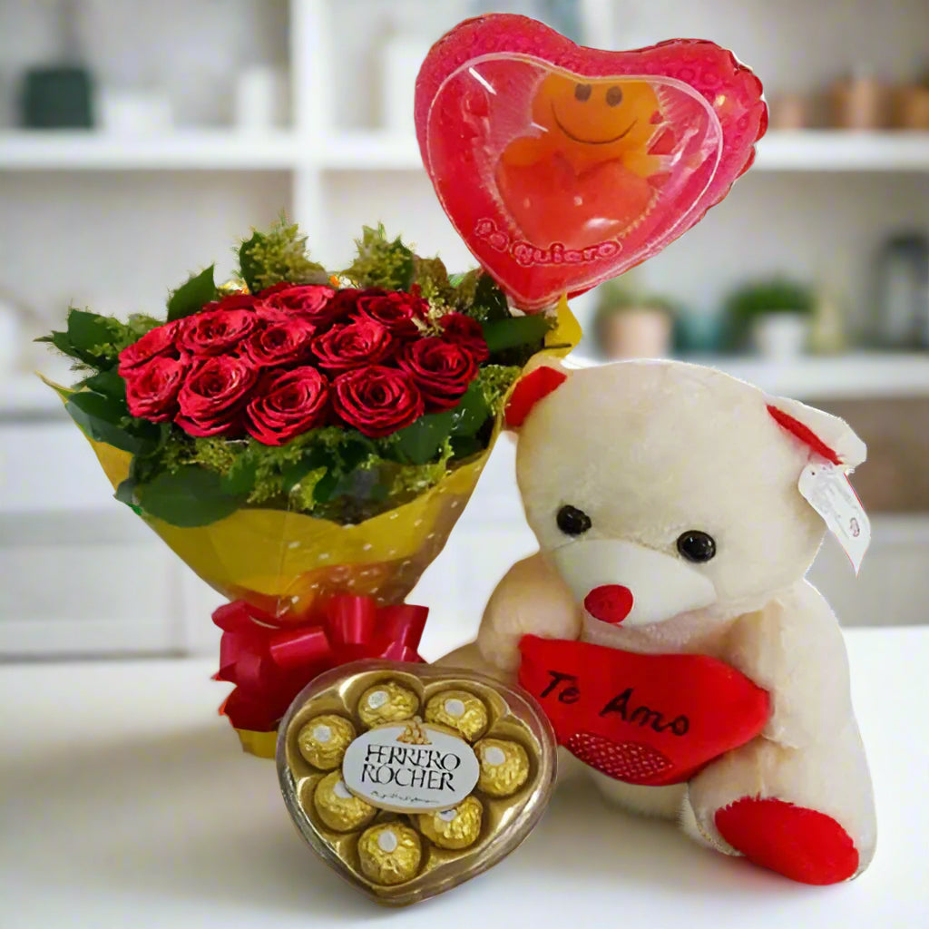 A romantic gift set featuring 12 red roses, an 11-inch teddy bear, a heart-shaped Ferrero Rocher chocolate box, and a 'Te Quiero' balloon, perfect for delivery in Colombia.