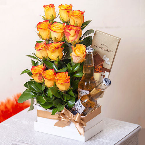 Arrangement of 12 confetti roses in a box with two Corona beers and special edition MontBlanc chocolate